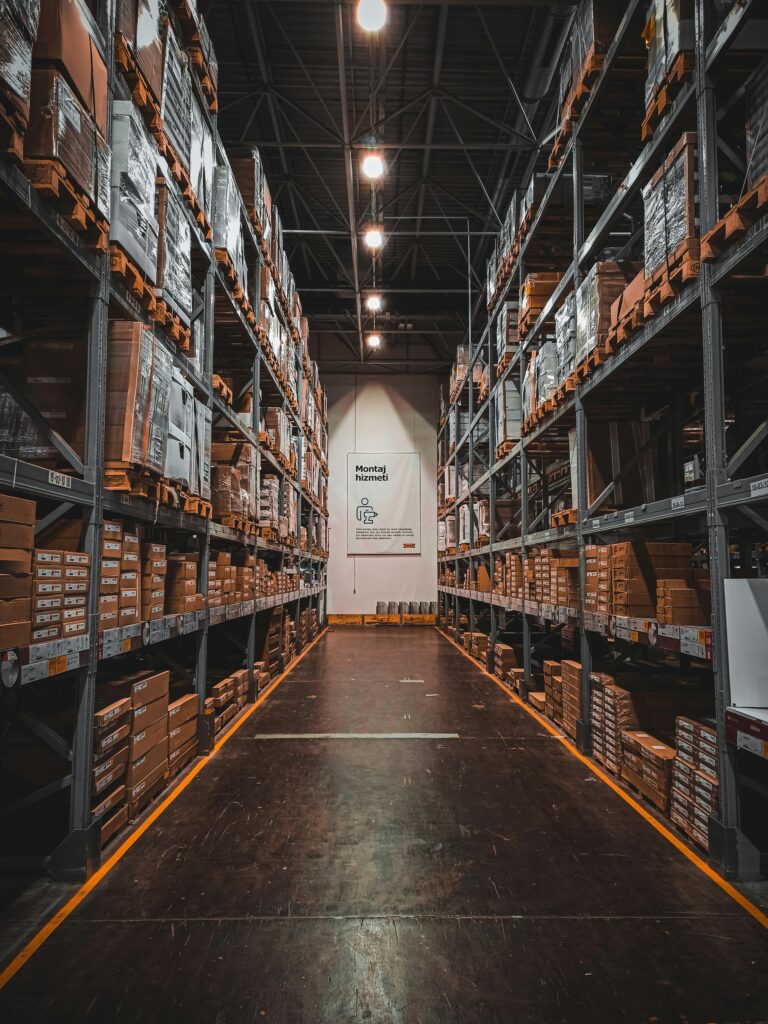 A well-organized warehouse aisle with stacks of goods on industrial storage racks, ensuring efficient logistics.